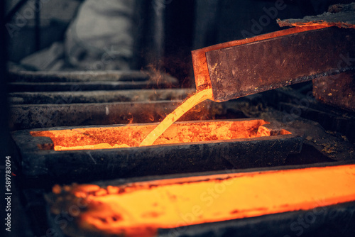 Foto red-hot brass melt pours into the mold in a foundry