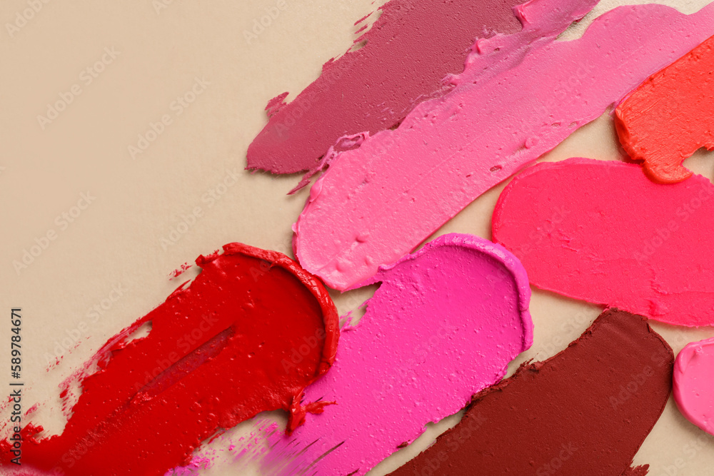 Different lipstick strokes on beige background Different lipstick strokes on beige background