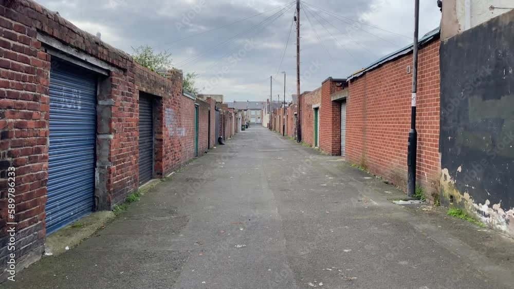 Panning shot of a small back alley within the street of the United Kingdom Panning shot of a small back alley within the street of the United Kingdom