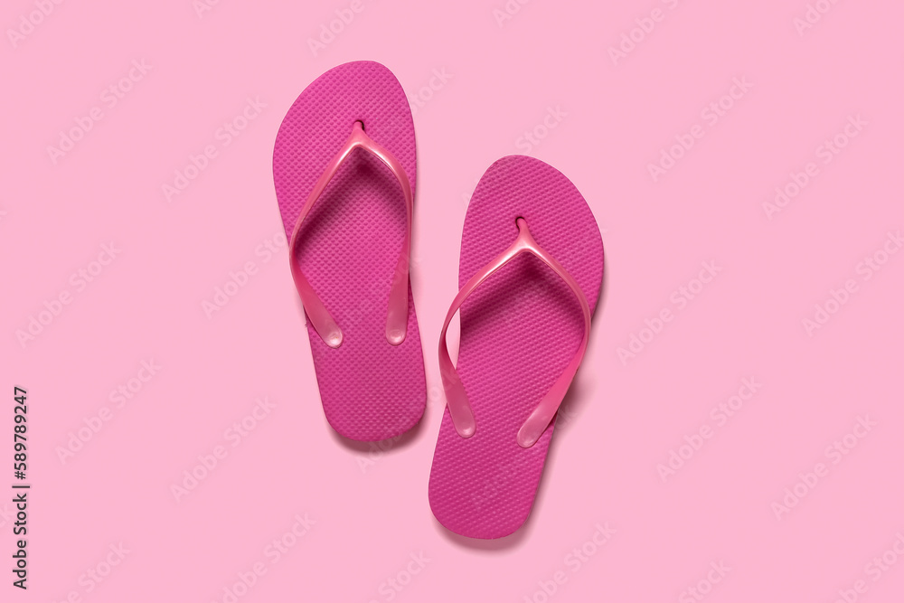 Flip-flops on pink background, top view Flip-flops on pink background, top view
