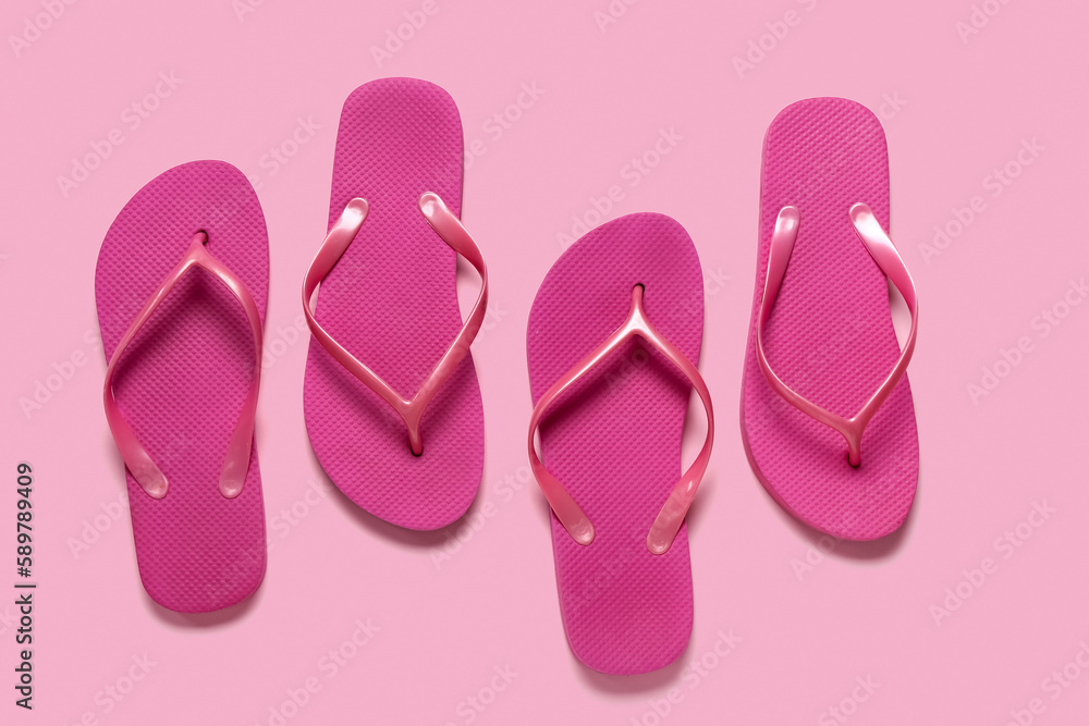 Flip-flops on pink background, top view Flip-flops on pink background, top view