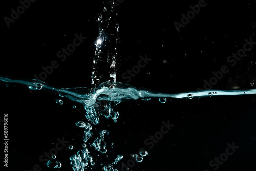 Water surface with bubbles on black background.