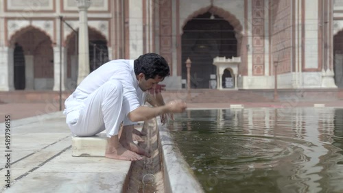 Wuzu cleansing being done at a mosque by an Indian muslim man