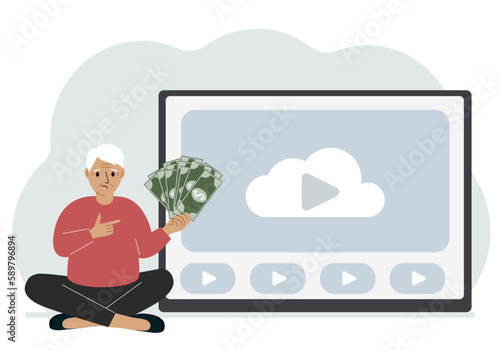 A man holds paper banknotes in his hand, next to a computer with a video. Freelancer, earning money, working on the Internet, training, coaching, business, remote work.