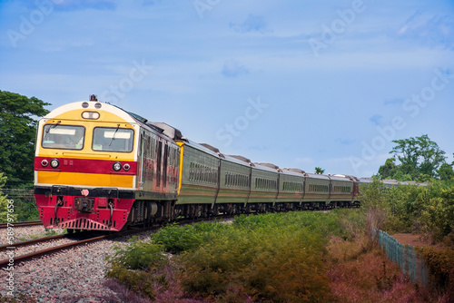 Passenger train by diesel locomotive passed the railway curve.