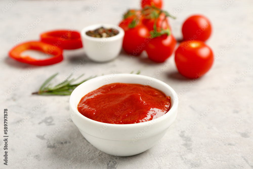 Bowl with tasty tomato paste on grunge background Bowl with tasty tomato paste on grunge background