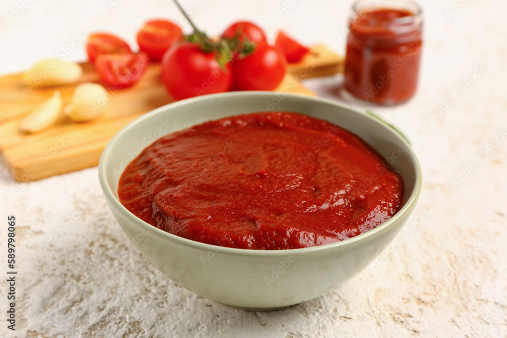 Bowl with tasty tomato paste on light background, closeup Bowl with tasty tomato paste on light background, closeup