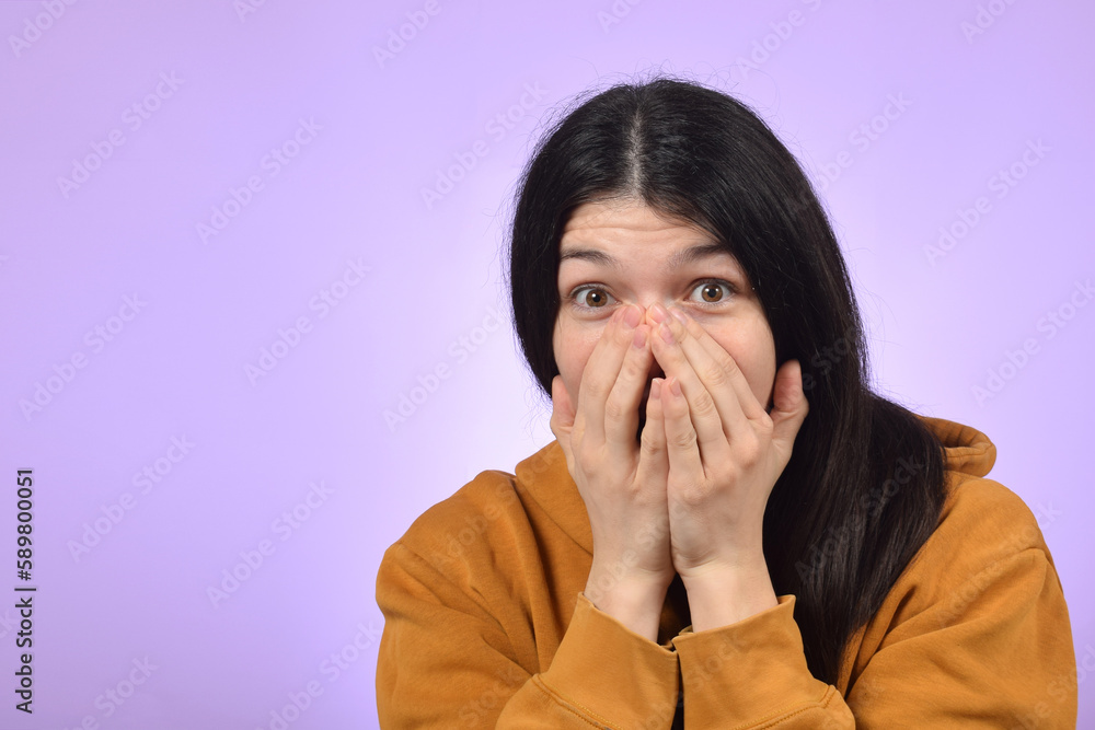 surprised young woman covered her face with her hands surprised young woman covered her face with her hands