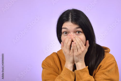 Wallpaper Mural surprised young woman covered her face with her hands Torontodigital.ca