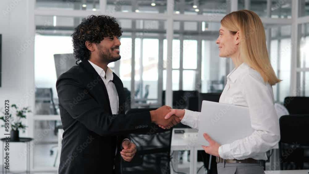 Indian businessman investor meets business partner in the office to celebrate successful completion of their business deal. Businesspeople are greeting each other, showing international cooperation. Indian businessman investor meets business partner in the office to celebrate successful completion of their business deal. Businesspeople are greeting each other, showing international cooperation.