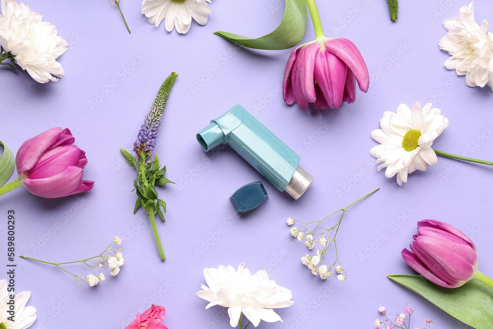 Asthma inhaler with flowers on lilac background Asthma inhaler with flowers on lilac background