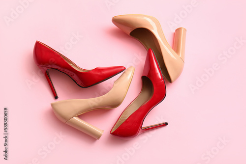 Fashionable high heeled shoes on pink background