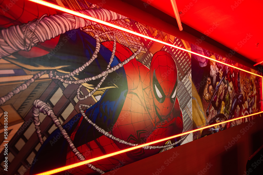 Naklejka premium Ternopil, Ukraine- March, 2023: Marvel super heroes poster in red play room.