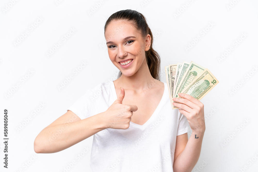 Young caucasian woman taking a lot of money isolated on white background giving a thumbs up gesture Young caucasian woman taking a lot of money isolated on white background giving a thumbs up gesture