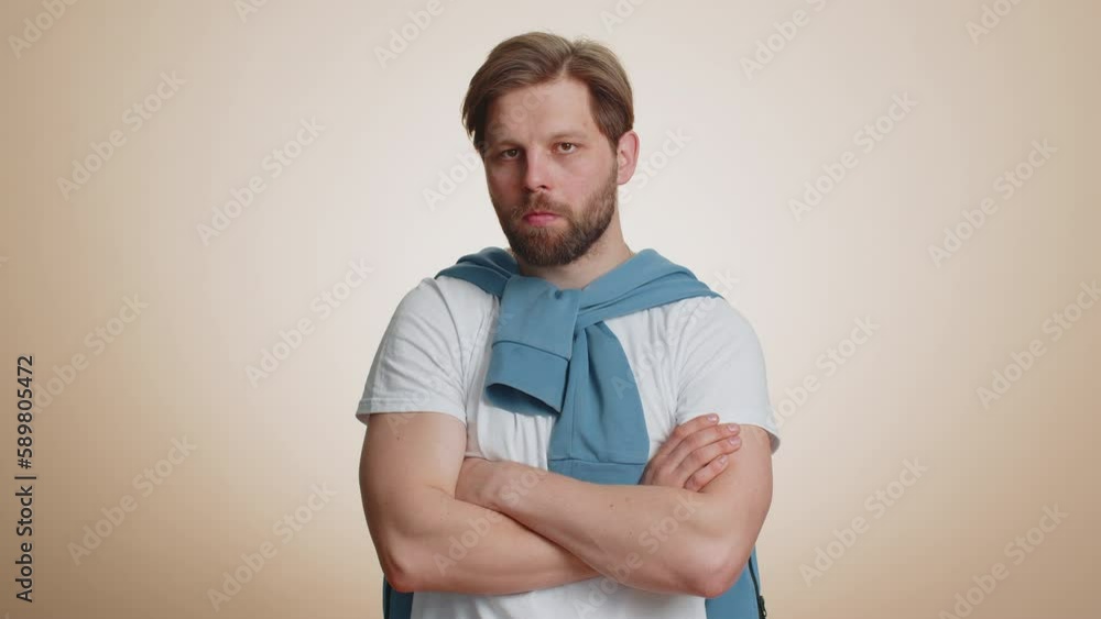 Young caucasian man showing tongue making childish faces at camera, fooling around, joking, aping with silly face, teasing, bullying abuse. Handsome guy isolated on studio beige background indoors Young caucasian man showing tongue making childish faces at camera, fooling around, joking, aping with silly face, teasing, bullying abuse. Handsome guy isolated on studio beige background indoors