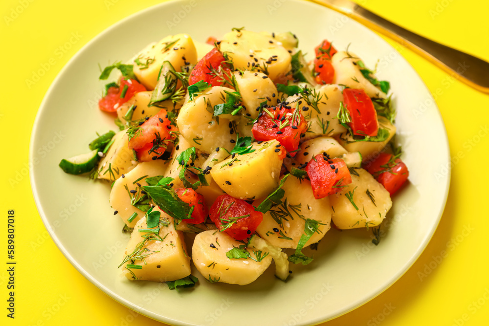 Plate of tasty Potato Salad with vegetables on yellow background, closeup Plate of tasty Potato Salad with vegetables on yellow background, closeup