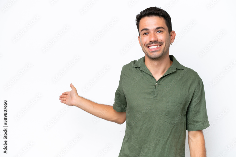 Young handsome man over isolated white background extending hands to the side for inviting to come Young handsome man over isolated white background extending hands to the side for inviting to come