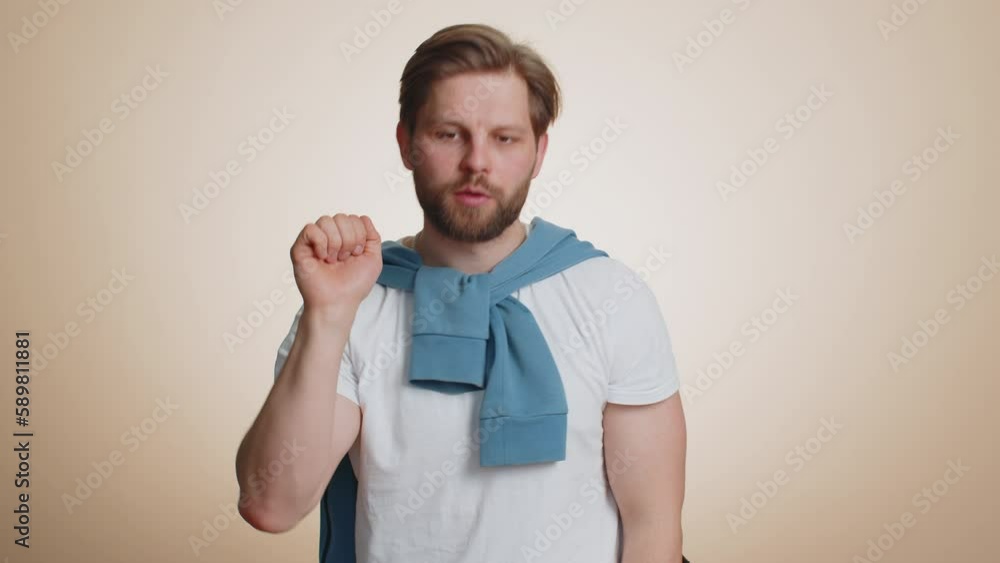Knock-knock who is there. Confused caucasian man knocking door gesture asking who is at home, feeling embarrassed, no idea, being clueless and uncertain. Young guy isolated on beige studio background Knock-knock who is there. Confused caucasian man knocking door gesture asking who is at home, feeling embarrassed, no idea, being clueless and uncertain. Young guy isolated on beige studio background