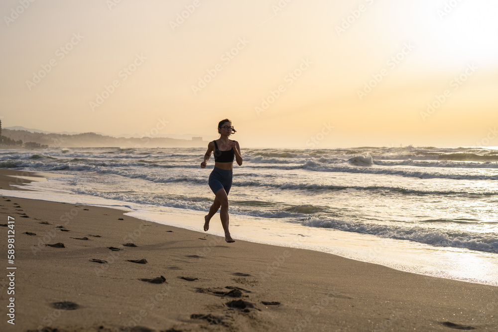 beautiful young girl running in the morning on the beach beautiful young girl running in the morning on the beach