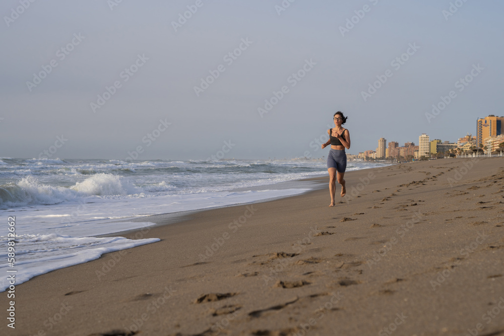 beautiful young girl running in the morning on the beach beautiful young girl running in the morning on the beach