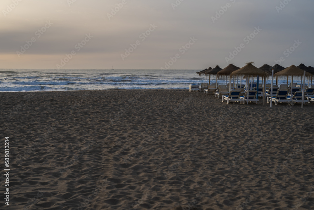 sunrise on the beach Surf sun loungers and awnings