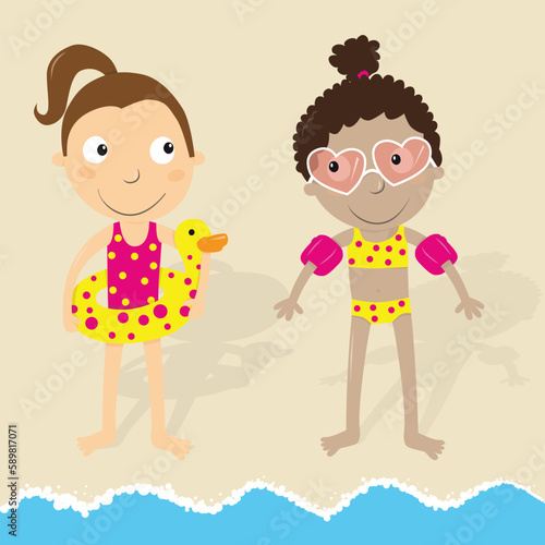 Girls on the beach ready to swim with inflatable ring and armbands