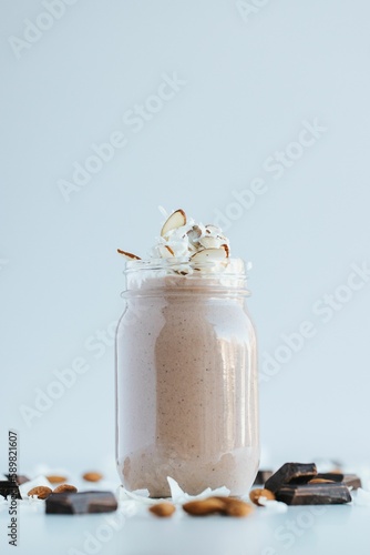 Vertical shot of a chocolate protein shake on the white background