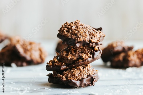 Closeup shot of a stack of no bake cookies dipped in chocolate on the marble kitchen counter