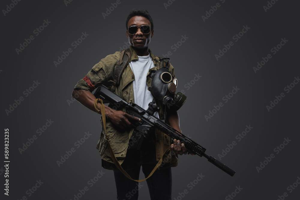 Studio shot of somali pirate man dressed in uniform posing agianst gray background. Studio shot of somali pirate man dressed in uniform posing agianst gray background.