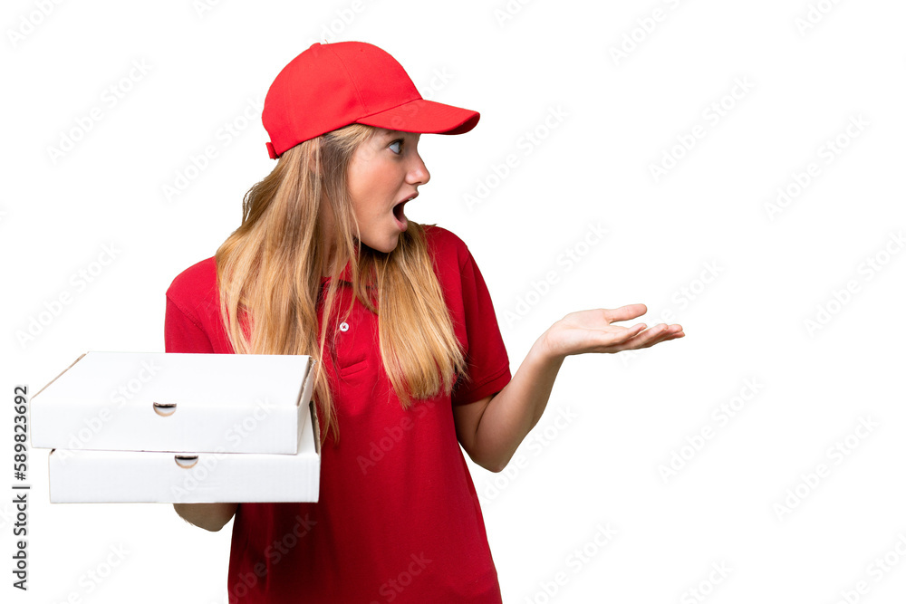 Young caucasian pizza delivery woman with work uniform picking up pizza boxes over isolated background with surprise expression while looking side Young caucasian pizza delivery woman with work uniform picking up pizza boxes over isolated background with surprise expression while looking side