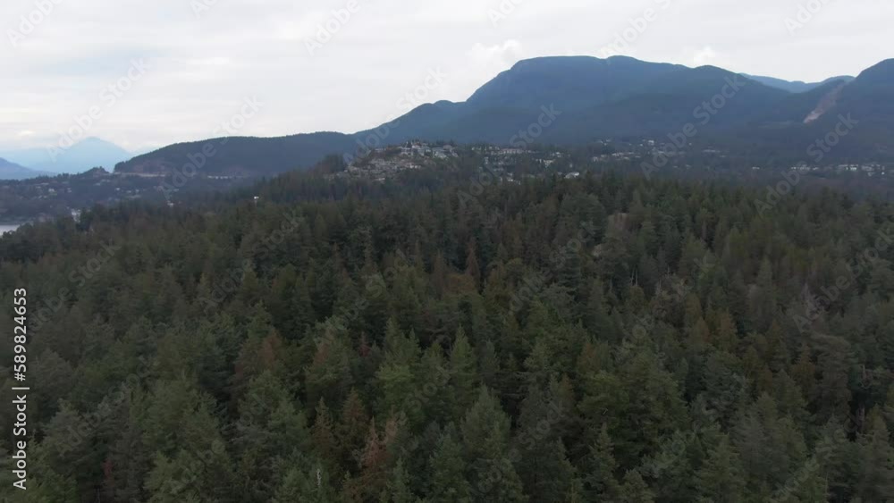 Drone shot of a the Point Atkinson Lighthouse on the coastline full of fir trees, British Columbia Drone shot of a the Point Atkinson Lighthouse on the coastline full of fir trees, British Columbia