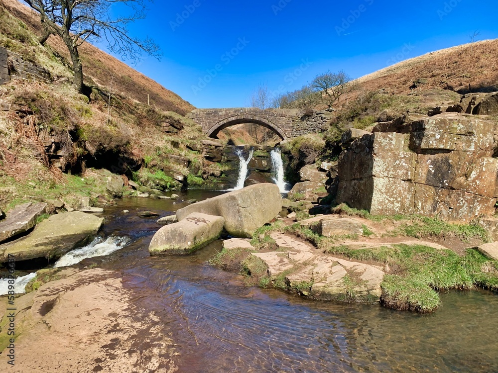 Three shires waterfalls stone arch bridge in the peak district uk 