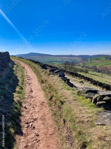 Hiking and walking track trail path in the peak district with countryside summer view