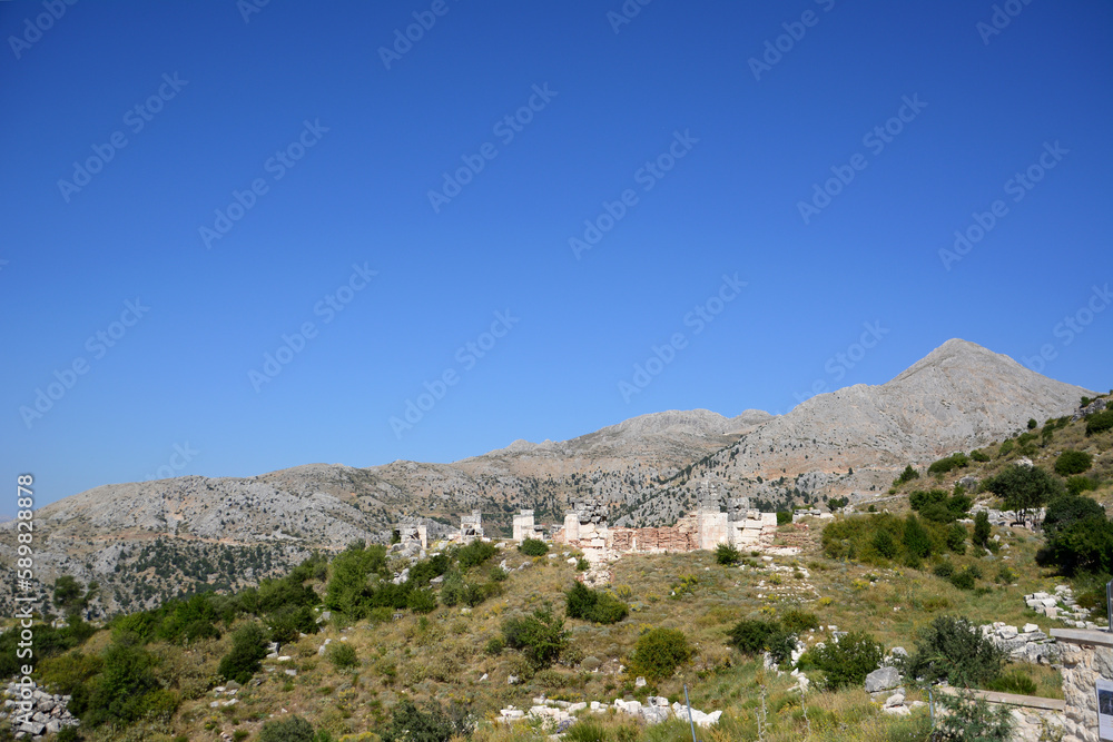 A view of the ruins of the old town Sagalassos with mountains and blue sky on background 