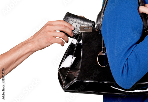 Pick pocket taking a wallet from a purse photo