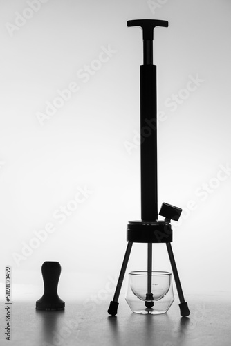 Vertical shot of the black Espresso Forge and glass accessories against white background