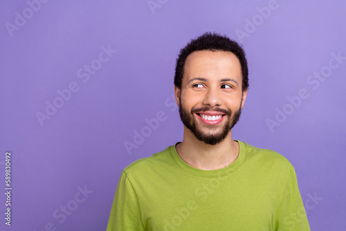 Photo of positive nice young person beaming smile look empty space isolated on violet color background