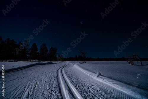 Snowy ski trail at night in Orsa Gronklitt, Sweden photo