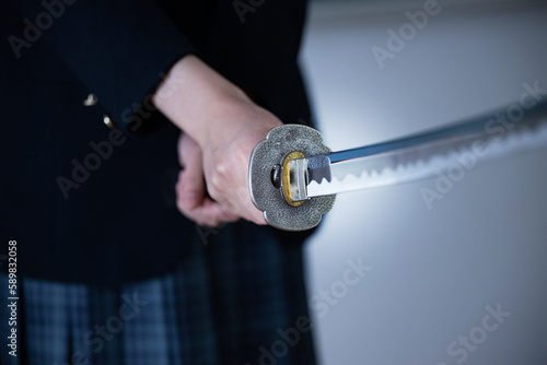 Image of a high school girl with a cool sword Close-up of a hand without face