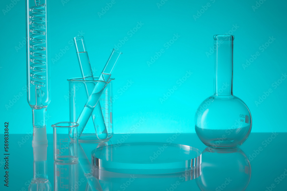 A round transparent podium displayed with a tube with spiral pipe inside, beakers, test tubes and a flat-bottom florence flask. Blank space to show your product A round transparent podium displayed with a tube with spiral pipe inside, beakers, test tubes and a flat-bottom florence flask. Blank space to show your product