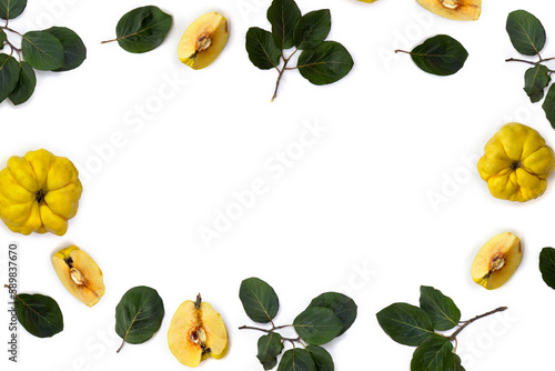 Ripe yellow juicy quince ( Cydonia oblonga ) with green leaves on a white background with space for text. Top view, flat lay