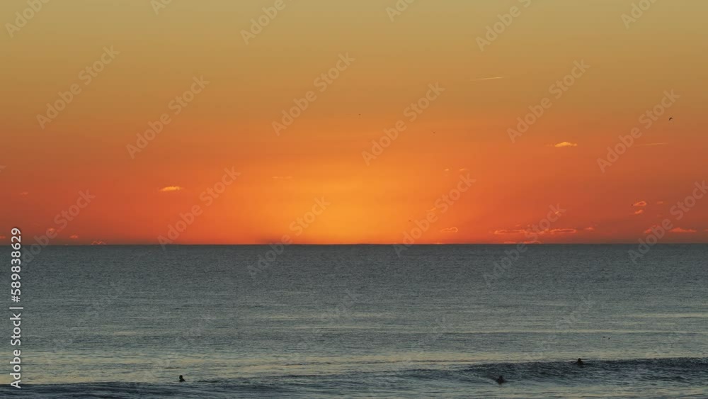 Surfers on the beach at the sunset background on the Atlantic coast of Portugal. Surfers on the beach at the sunset background on the Atlantic coast of Portugal.