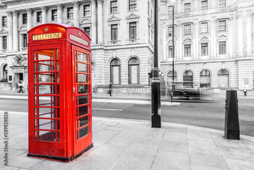 London red telephone booth on city street.