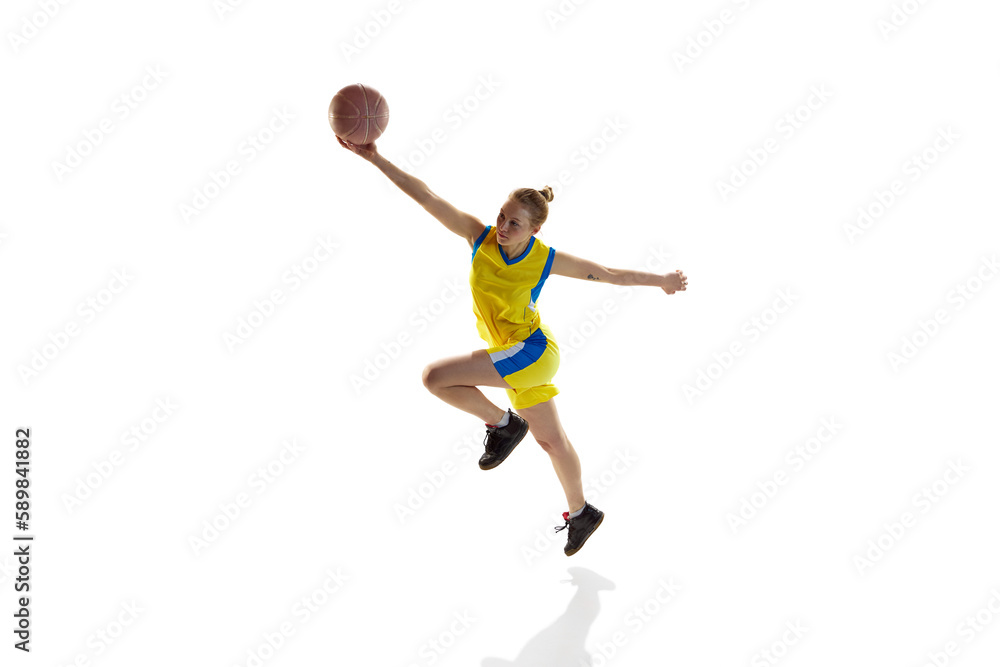 Young sportive girl in uniform, training with ball, playing basketball against white studio background. Isometric view. Concept of professional sport, hobby, healthy lifestyle, action and motion