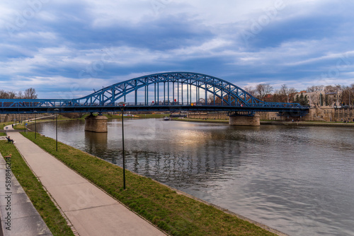 Jozef Pilsudski Bridge, the oldest road bridge across the Vistula in Krakow connects Kazimierz and Podgórze, Krakow Technique Way tourist route, cloudy spring day, street photography