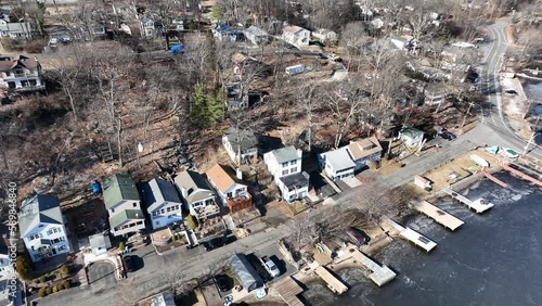 Aerial view of the Hopatcong lake covered in ice, dry trees and old houses around it in New Jersey photo