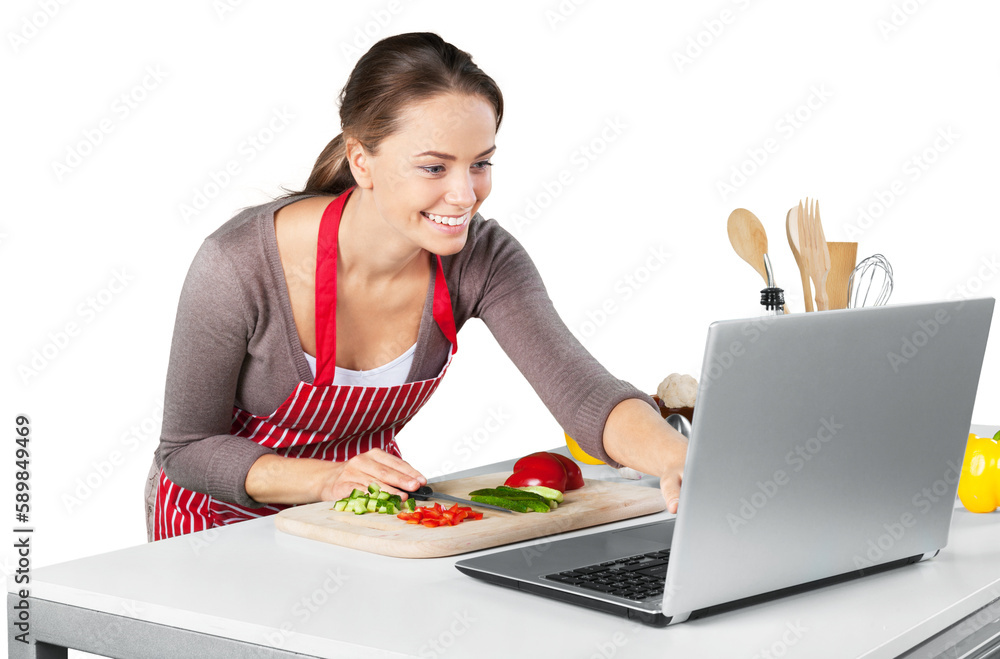 Portrait of a Woman Cooking and Looking at Laptop in Kitchen Portrait of a Woman Cooking and Looking at Laptop in Kitchen