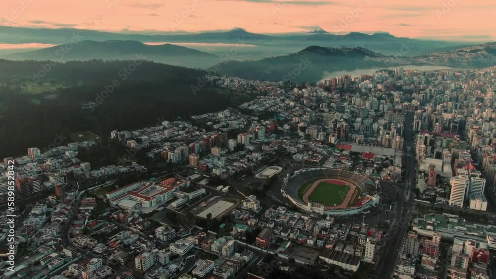 Aerial view of a city with green vegetation at calm sunset Aerial view of a city with green vegetation at calm sunset