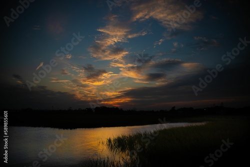Beautiful sunset on Shem creek with a cloudy blue sky in the background, South Carolina photo
