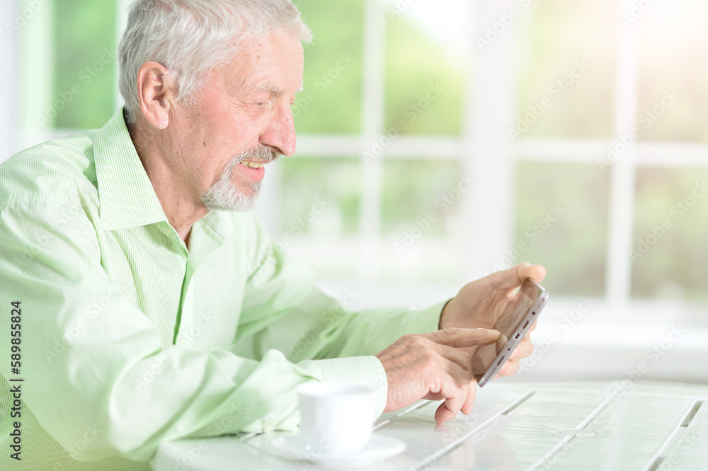 Thoughtful old man with tablet at home Thoughtful old man with tablet at home